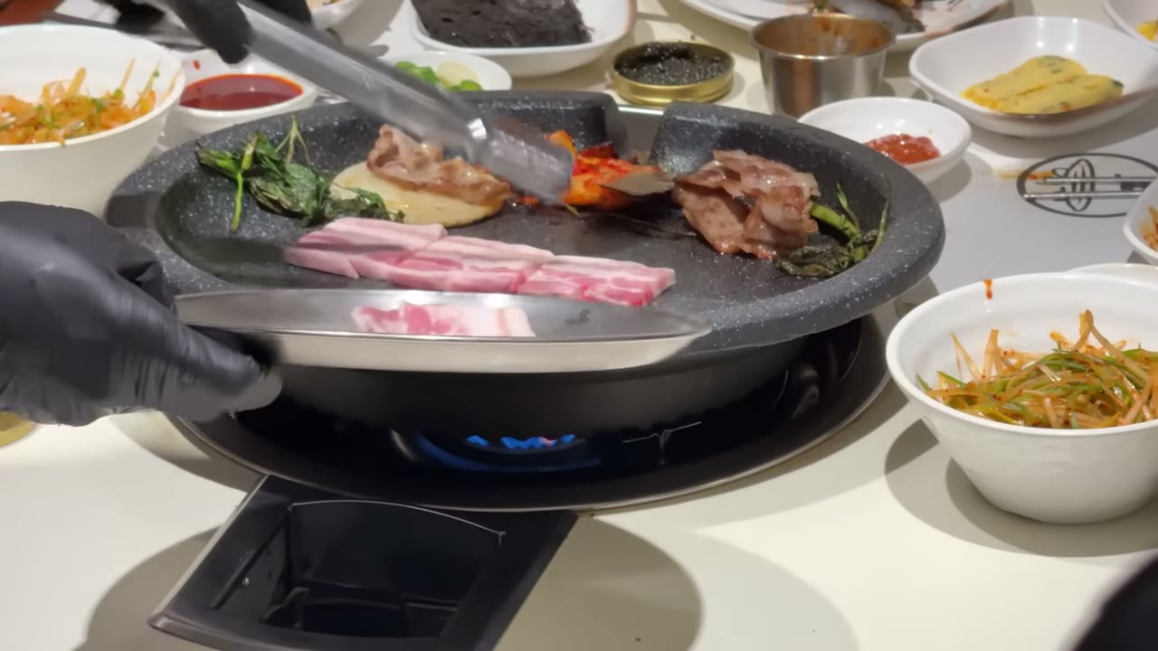불판에 오른 삼겹살과 기본찬